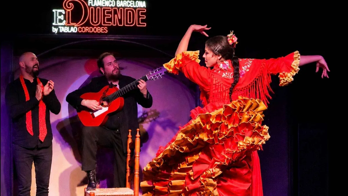 Guitarist and dancer performing close to the tables at El Duende flamenco bar, a flamenco show in Barcelona, Spain