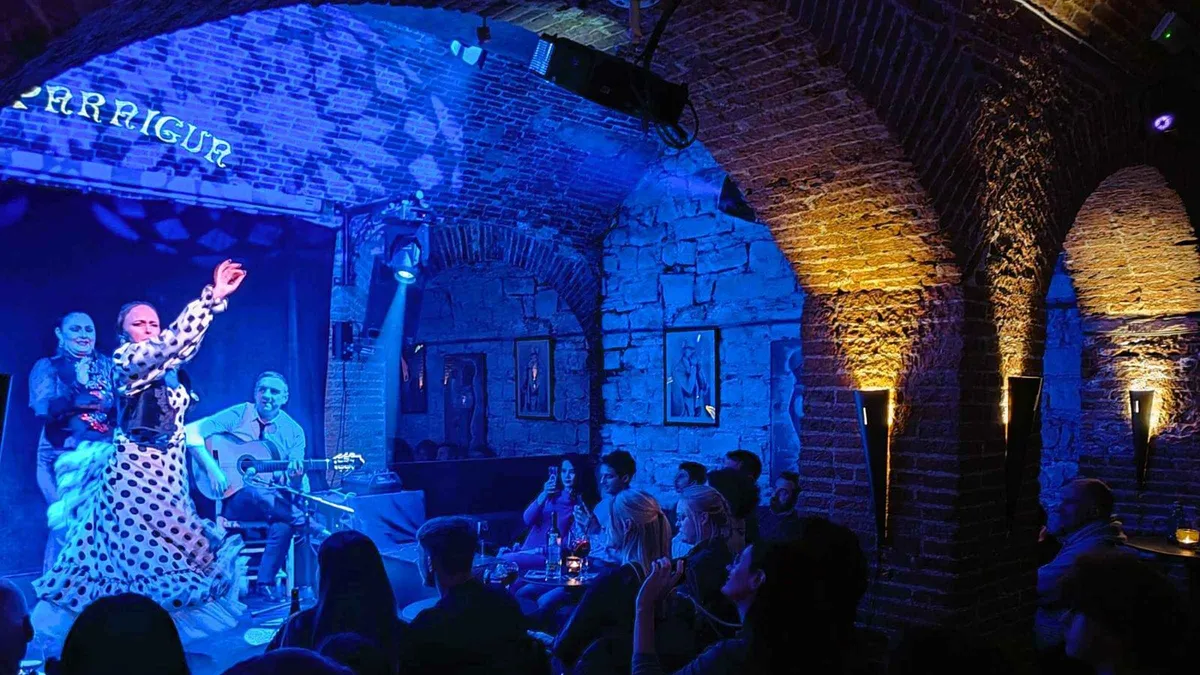 Flamenco dancer performing in the vaulted stone cellar of El Paraigua at a flamenco show in Barcelona's Gothic Quarter, Spain